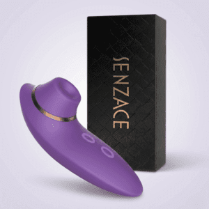 A studio shot of the purple AquaSensual Clit Sucker from TheSexToysIndia displayed alongside its elegant black "SENZACE" textured storage box.